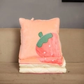 Detail of plush strawberry pattern pillow blanket unfolded on a beige sofa - New Strawberry / Folded 40x40cm Unfolded 115x145cm