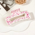 Detail of a rectangular hair claw clip with pink and red heart-shaped leopard print patterns - 8.5cm Heart Print - Style D White Base
