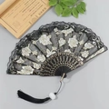 Elegant black lace folding fan with white rose embroidery and golden bone patterns - Fan with Tassel / Black