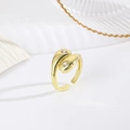 Close-up of 18k gold plated open ring with heart-shaped zircon stones on white surface - Heart Open Style / Gold