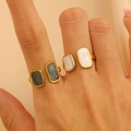 Detail of 18K gold plated stainless steel rings with marble and cream enamel inlay - Square Marble Pattern Open Set of 2