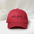 Detail shot of MILANO ITALY brown 3D embroidery on a premium dark red cotton baseball cap - Red