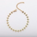 Close-up of gold stainless steel bracelet featuring green evil eye charms and lobster clasp - Gold/Green