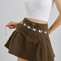 Detail view of silver butterfly link chain belt worn over a pleated skirt - Silver - Hollow Butterfly