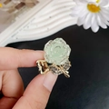 Sparkling light green flower hair claw clip with gold metal and rhinestone leaf detail - Green