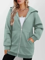 Detail of pea green zip-up hoodie featuring hooded design, dual pockets and ribbed cuffs - Green
