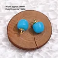 Pair of blue apple-shaped glass pendants with gold clasps on a wooden display - 15# Blue Apple