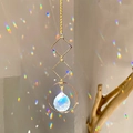 Golden geometric suncatcher with transparent crystal prism casting rainbow light - B15 Style