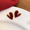 Close-up of heart-shaped burgundy enamel earrings with golden edges on a ceramic plate - Irregular Heart (8#)