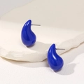 Macro detail of royal blue teardrop earrings with smooth glaze finish on white stone - Dark Blue
