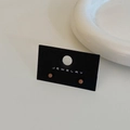 Detail of round orange-brown bean studs on black jewelry card with white ceramic background - Coffee Color Stud Earrings