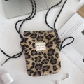 Close-up of leopard print plush crossbody phone bag with woven strap and metal buckle - Yellow Leopard