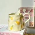 Beige ceramic mug with pineapple and pear patterns including matching spoon - Pineapple Mug + Star Spoon