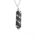 Detail of a black obsidian hexagonal point pendant wrapped in silver spiral wire - Silver + Obsidian