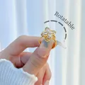 Rotatable flower ring in gold-plated copper with clear zircon stones for women - Rhinestone Clover Rotatable Style (H002)