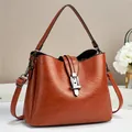 Retro caramel brown leather bucket bag with silver buckle and adjustable strap - Earthy Yellow