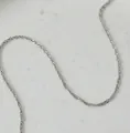 Detailed close-up showing the twisted structure of a silver water wave chain necklace - 50 cm / Water Wave Chain (Silver)
