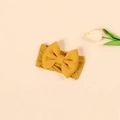 Detailed close-up of a ginger yellow baby nylon headband with a soft oversized bow - Ginger Yellow