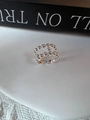 Detailed view of silver multi-layered beaded ring on a white minimalist background - Silver