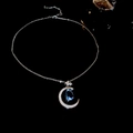 Elegant silver crescent moon necklace with a blue waterdrop zircon on a black background - Silver Blue