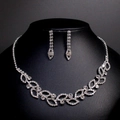 Elegant silver bridal jewelry set with sparkling rhinestones on a black display neck - TL081/Silver Floral Leaf Style
