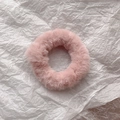 Close-up of soft pink faux rabbit fur scrunchie showing fluffy texture on white paper - Peach