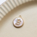 Close-up of gold plated round letter B pendant with zircon and white shell inlay - B Round