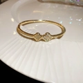 Macro detail of 18k gold plated clover bracelet with sparkling white zircon inlays - 16# Golden Clover