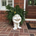Funny Muggly face planter with a big smile and small feet on a rustic brick patio - Happy Auntie