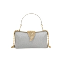 Silver glitter evening clutch bag with golden round handle and leaf clasp design - Silver
