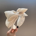 Oversized seersucker bow headband in cream white with pleated fabric texture - Beige