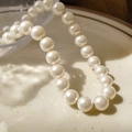 Elegant 2mm white crystal pearl necklace displayed on a textured ceramic plate - 10mm White