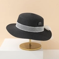 Elegant black straw sun hat with white mesh ribbon and pearl detail on a metal stand - Black