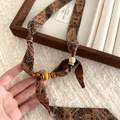Detailed view of bohemian paisley fabric necklace with brown ceramic and wooden beads - Necklace-Brown-Paisley