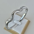 Silver wavy stainless steel bracelet with row of pave cubic zirconia stones - Wave Shape Silver Bangle