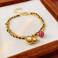 Gold double-layer bracelet with calabash charm and pink gemstone bead on brown tray - 31# Bracelet - Gold and Black