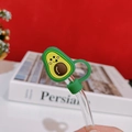 Macro detail of curved glass straw with a cute green avocado silicone dust plug protector - Avocado Straw Cover
