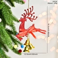 Sparkling red reindeer Christmas ornament with bow and bells hanging on a festive tree - Red
