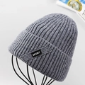 Close-up of grey ribbed knit beanie for men with Sport woven label on a metal stand - Light Gray