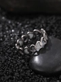 Macro detail of silver stainless steel ring with hollow heart design on a grey stone - Couple Heart Style (NR303)