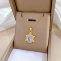 Dettaglio del ciondolo a tartaruga dorata con zircone in una scatola regalo - Oro-Zircone Bianco
