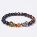 Close-up of dual dragon heads and tiger eye beads on a beaded stretch bracelet - Red Tiger Eye & Matte Stone