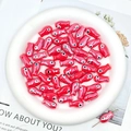 Detailed view of red ceramic fish-shaped beads with glossy finish for DIY jewelry crafts - Red
