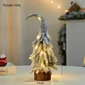 Mini snow-flocked PE Christmas tree with warm LED lights and a natural wood base - Snowy Crooked Tree Medium with LED Light