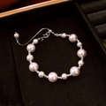 French style irregular pearl bracelet with silver textured beads on black jewelry tray - Silver Textured Spacer Bead Pull Pearl Bracelet