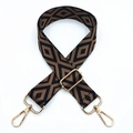 Close-up of geometric diamond pattern embroidery on adjustable woven bag strap with gold hooks - Black Base Brown