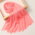 Elegant pink linen cotton scarf with decorative fringe placed on a wooden tray - 180*100cm / Watermelon Red (TH39-7)