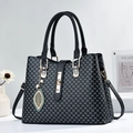 Classic black leather tote bag with white monogram print and gold leaf charm detail - Black