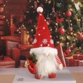 Christmas gnome doll with red hat and gift bag on festive background scene - Red