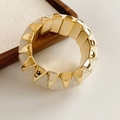 Detail of geometric stretch bracelet with gold metal and marble textured blocks - White